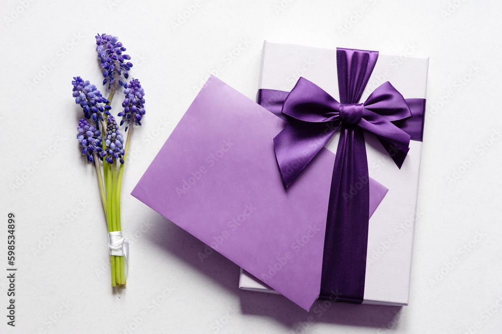 Canvas Prints Happy mother's day, women's day, birthday or wedding. Flat lay composition with muscari flowers, gift box and envelope mockup with blank greeting card on light background. Minimal floral frame.