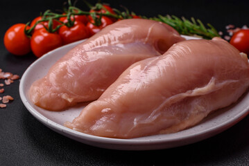 Pieces of raw chicken or turkey fillet with salt, spices and herbs