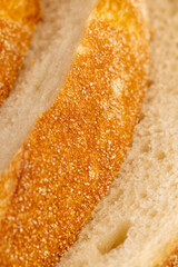 A cut loaf of round-shaped wheat bread