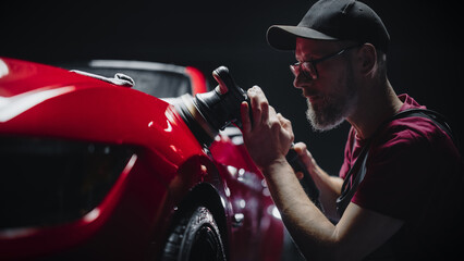 Portrait of an Adult Man Working in a Detailing Studio, Prepping a Factory Fresh American Sportscar...