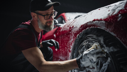 Portrait of an Adult Man Working in a Detailing Studio, Prepping a Factory Fresh American Sportscar...