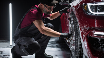 Portrait of an Adult Man Working in a Detailing Studio, Prepping a Factory Fresh American Sportscar...