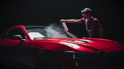 Portrait of a Car Detailer Spreading a Chemical Wax Solution for Polishing a Windshield and...