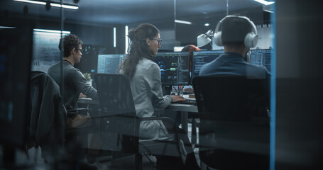 Group of Multicultural Men and Women Working in a Research Center, Collaborating and Discussing a...