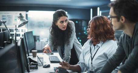 Team of Three Multiethnic Diverse Software Developers Talk, Discuss an AI Project. Empowered Black...
