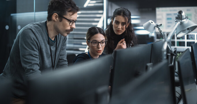 Team of Three Multiethnic Diverse Software Developers Talk, Discuss an AI Project. Stylish Young Specialists Work on Digital E-Commerce Startup Business