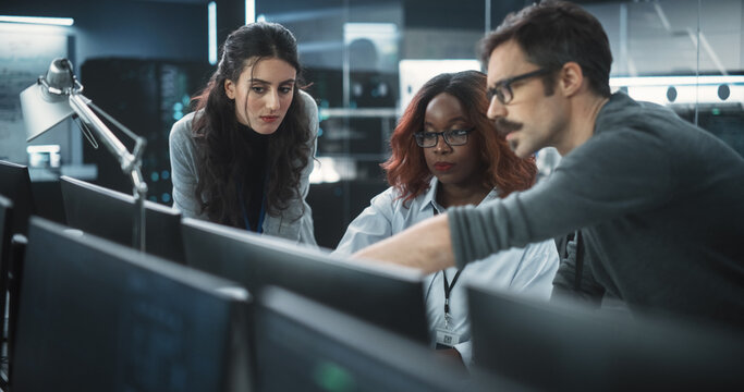 Group of Empowered Multicultural Specialists Working in a Research Center, Using Computer to Collaborate on Advanced Software, Develop Artificial Intelligence Interface and Cloud-Based Blockchain