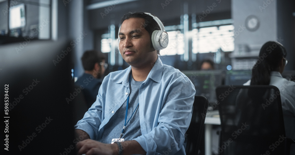 Aufkleber Indian System Administrator Working in a Research E-Business Facility on a Desktop Computer. Focused Software Developer in Casual Clothes Wearing Headphones and Updating Server System Database