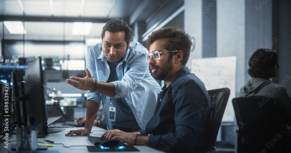 Fototapete Creative Team of Indian Specialists Having a Conversation at a Workplace Next to Computer. Two Male Software Engineers Discussing a Software Code for Their Digital Blockchain Development Project