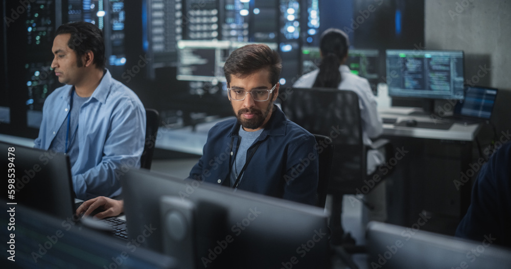 Aufkleber Young Team of South Asian Specialists Working on Computers and Having a Conversation at a Workplace. Two Male Software Developers Discussing a Solution for Their Artificial Intelligence Project