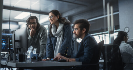 Group of Three Young Indian Software Engineers Use Computer to Discuss a Technological Project in...