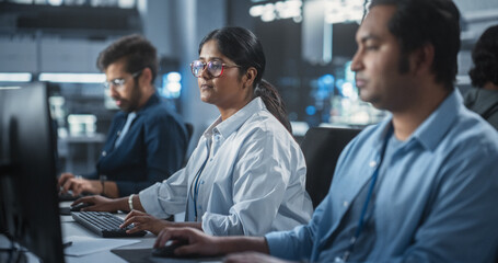 Young Team of Female and Male South Asian Specialists Working on Computers and Having a...