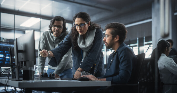 Team Of Three Diverse South Asian Software Developers Talk, Discuss A Technological Project. Empowered Indian Female Specialists And Two Colleagues Work On Digital Software As A Service Business