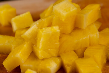 sliced pulp of peeled ripe pineapple , close up