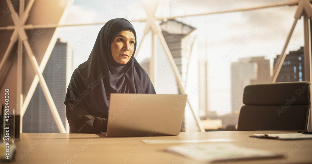 Aufkleber portrait of a young female business account manager working on a laptop computer in a modern corpora