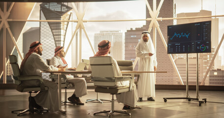 Modern Middle Eastern Business Office Meeting: Confident Arab Businessman Uses Interactive Display, Makes Report to a Group of Corporate Partners, Shows Statistics, Growth and Financial Analytics