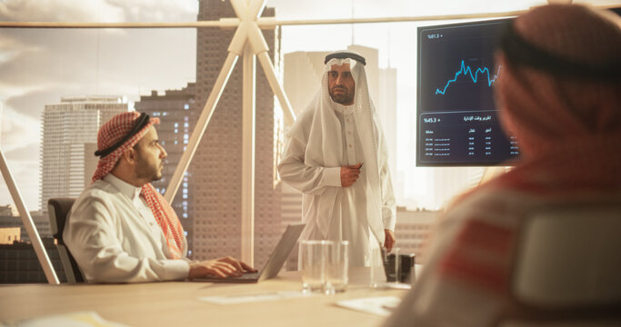 Muslim Businessman Holds Meeting Presentation for Middle Eastern Business Partners. Manager Uses Digital Display with Growth Analytics, Charts, Statistics and Data. Saudi, Emirati, Arab Office Concept