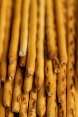 Thin and long bread sticks made of wheat flour on the table
