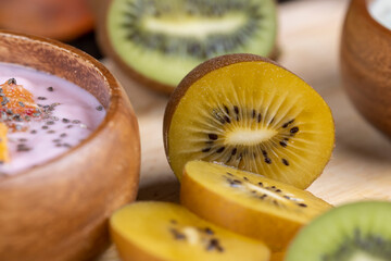 green and yellow kiwi fruit cut into pieces, close up