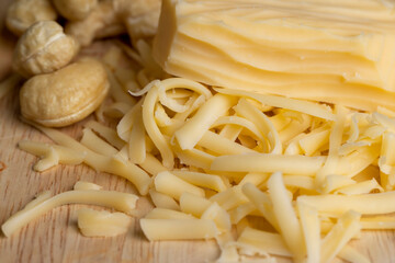Sliced and grated hard cheese with cashew nuts