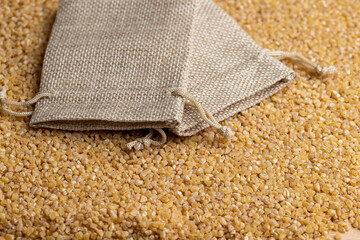Not cooked wheat porridge in a linen bag