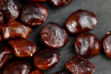 brown tamarind seeds on the table, scattered seeds