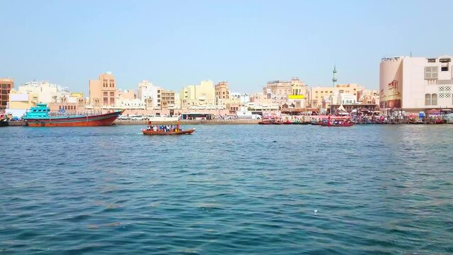 The fast traffic of abra boats, floating across Dubai Creek, connecting Bur Dubai district with Deira Old Souk, Dubai