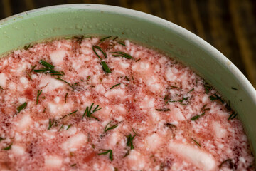 a bowl of traditional red beet borscht with sour cream and dill