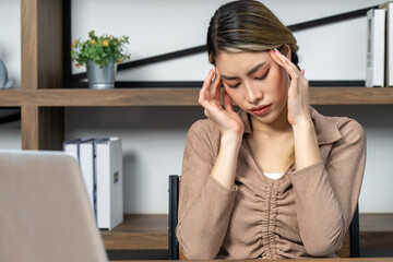 Young woman working on laptop computer at home