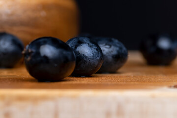 Wet black and blue grapes on the table