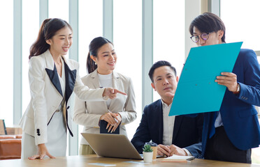 Group of Asian stressed depressed worried tired professional successful female businesswomen and male businessmen employees in formal business suit arguing disagreement about strategy in meeting room