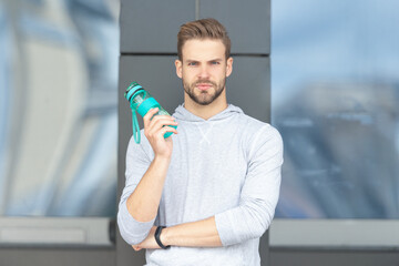 thirsty sportsman holding water. thirsty sportsman with water bottle. thirsty sportsman with water