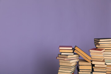 a stack of books on a purple background in the library in the office