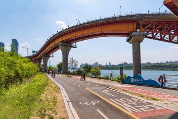 Fototapeta na wymiar Bike road under the bridge at river front-Seoul, Korea