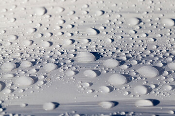 plastic surface of grass packaging covered with water droplets