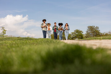 young generation z boys with mobile phone - addicted to social networks, walking looking at their cell phone