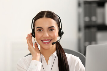 Hotline operator with headset working in office