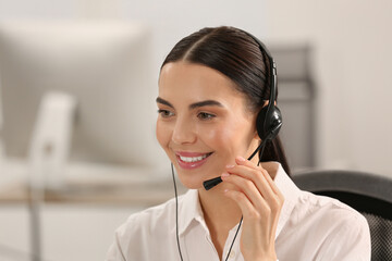 Hotline operator with headset working in office