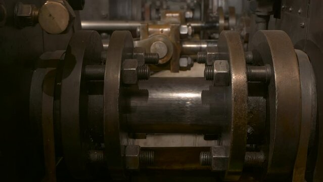 An old engines driving a force pump from its piston tail rod.