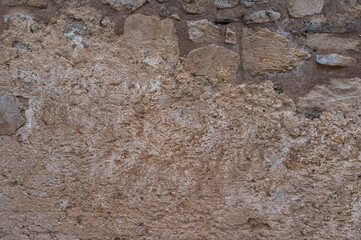 imagen detalle textura pared de piedras de distintos tamaños y formas, con las juntas de cemento, y rebozado en mal estado 