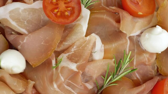 Raw ham. Slices of Jinhua raw ham, with fresh rosemary, mozzarella and tomatoes