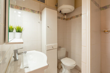Fototapeta na wymiar Home bathroom, bright new bathroom interior with tiled glass shower, vanity cabinet, white designed interior