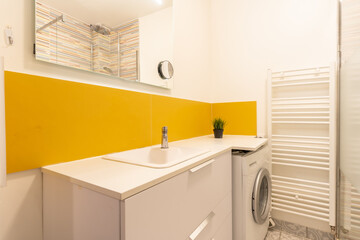Home bathroom, bright new bathroom interior with tiled glass shower, vanity cabinet, interior designed white and yellow