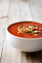 Traditional Spanish gazpacho soup in bowl on wooden table. Copy space