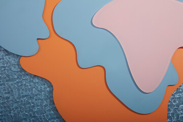 Creative modern background with many layers of colorful acrylic sheets with orange, blue and pink colors. Design banner, poster or display products