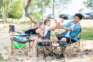 Family enjoying a camping holiday in the countryside ,Camping, travel, tourism, hiking and people. Concept - Happy family with backpacks and thermos at camp.