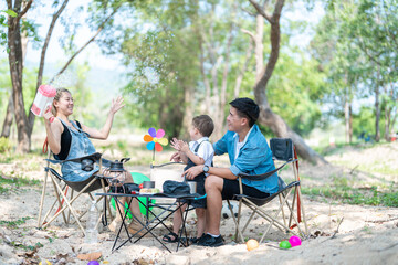 Family enjoying a camping holiday in the countryside ,Camping, travel, tourism, hiking and people. Concept - Happy family with backpacks and thermos at camp.