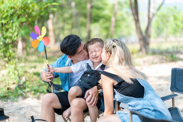 Family enjoying a camping holiday in the countryside ,Camping, travel, tourism, hiking and people. Concept - Happy family with backpacks and thermos at camp.