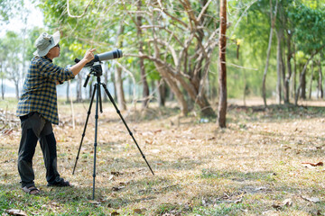 Bird watchers with tripod and spotting scope.