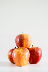 Three fresh red apples on a white background.